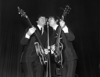 Paul Berriff; Reflections, 1963, Original Photography Black and White, 42 x 33 inches. Artwork description: 241  Paul McCaartney and George Harrison Share the microphone on stage at the ABC Theater Huddersfield England on 29 November 1963 during The Beatles first UK tour.  This is a limited edition and comes signed on the verso by the photographer Paul Berriff with limited edition number and ...