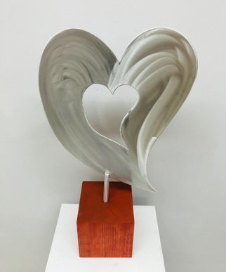Mac Worthington: 'love comes 1st', 2021 Aluminum Sculpture, Figurative. Tabletop sculpture.High Polished with a machine brush finish on a Cherry block, 23  x 1  x 5. 5 .Available. Signed   dated. Certificate of Authenticity.Delivery, hanging   shipping availableStudio: 5935 Houseman Rd, historic Ostrander, Ohio.For further information on this piece or to discuss a custom design please call ...