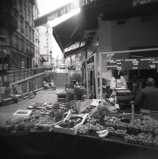 Karen Morecroft; Fruit Seller In Paris, 2009, Original Photography Black and White, 5 x 5 inches. Artwork description: 241  A grocer on the streets of Paris, France selling fruit and other goods. Photo mounted on black card ( approx 6x8)  ...