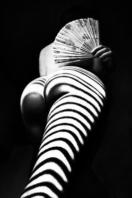 Mikhail Faletkin: 'zebra with a fan', 2017 Black and White Photograph, Nudes. In this work, a fan is added to the shadows of the  zebra  type. The lower angle is used. The shadow of the zebra reaches the middle of the body of the model and, as it were, accumulates in the fan . . .Limited signed edition 2 of 10...