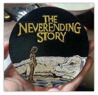 Nicole Calise: 'the neverending story coaster 1 of 6', 2021 Leather, Movies. The NeverEnding Story Leather Coaster Set is comprised of 6 Hand Carved Hand Painted Coasters.  This piece is coaster number 1 in the set.  These coasters are 100veg- tan leather.Hand carved and painstakingly hand painted and sealed.  Each coaster features a cork backing and is burnished with my logo.  ...