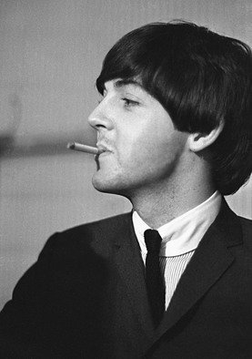Paul Berriff: 'Bad Boy Next Door', 1964 Black and White Photograph, Music.  Paul McCartney with a mischievous look takes time out for a cigarette before The Beatles concert in Leeds England on 22 October 1964.  This is a limited edition and comes signed on the verso by the photographer Paul Berriff with limited edition number and authenticity certificate.  The image is produced...