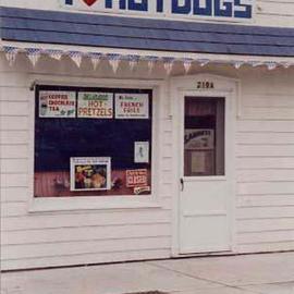 Ruth Zachary: 'America Eats', 1994 Color Photograph, Americana. Artist Description: American store front delicatessen featuring hot dogs! Great graphic shapes, style and humor. Bright red, white and blue colors with American flag streamer detail. I have it hanging in my kitchen. Always gets a smile. And, who doesnt	love a hot dog? ! Greenport, Long Island. Signed and titled. ...