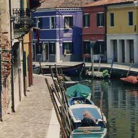 Ruth Zachary: 'Colors of Burano I', 1997 Color Photograph, Travel. Artist Description: Island of Burano, Venice, Italy.  A small island famous for its hand- made lace and its exciting, unexpected colors: orchid, rose, yellow, white. Almost tropical, festive.  Cobblestones, old brick,  wrought iron window trim.  The sweep of the canal provides movement and drama.  Boats, of course.  Limited edition, signed ...
