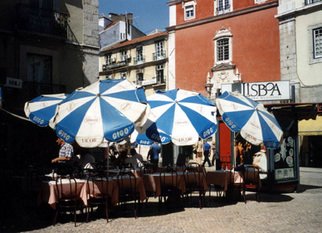 Ruth Zachary: 'Umbrellas of Lisbon', 1996 Color Photograph, Travel.  Cheerful, charming row of umbrellas. Charming street scene. Take a seat and order a coffee. People- watch. Interesting lines and colorful contrast.  Lisbon, Portugal.  5 x 7 in an 11 x 14 acid free mat. Signed and titled. Larger size available.  Enjoy! ...